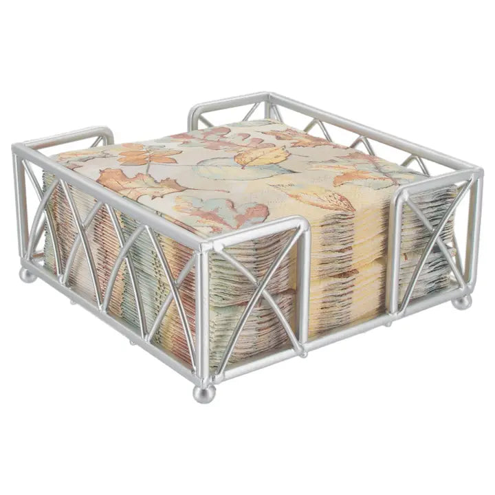 Metallic napkin holder with floral-patterned napkins on a white background