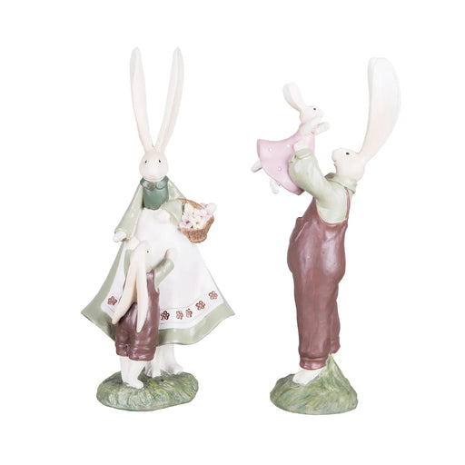 Two rabbit figurines, one holding a child and the other with a baby, on a white background.