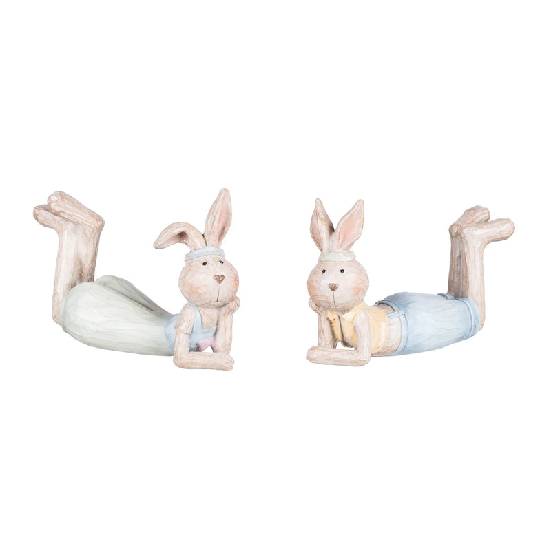 Two rabbit figurines performing yoga poses on a white background