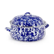Blue and white speckled enameled cast iron cookware on a white background