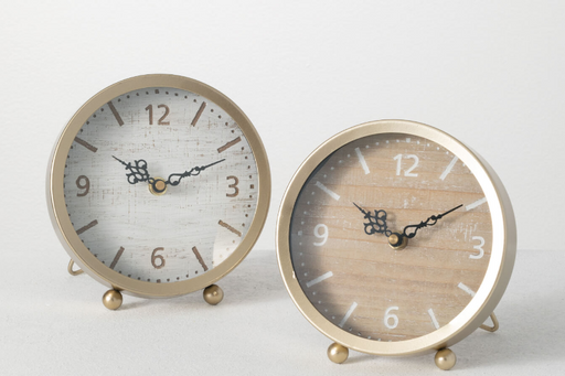 Two round alarm clocks with gold frames on a white background