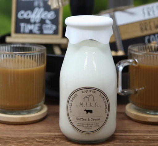 Milk bottle labeled 'Coffee & Cream' with two glasses of coffee in the background.