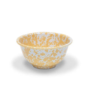 A yellow and white marble splattered small footed enamel bowl.