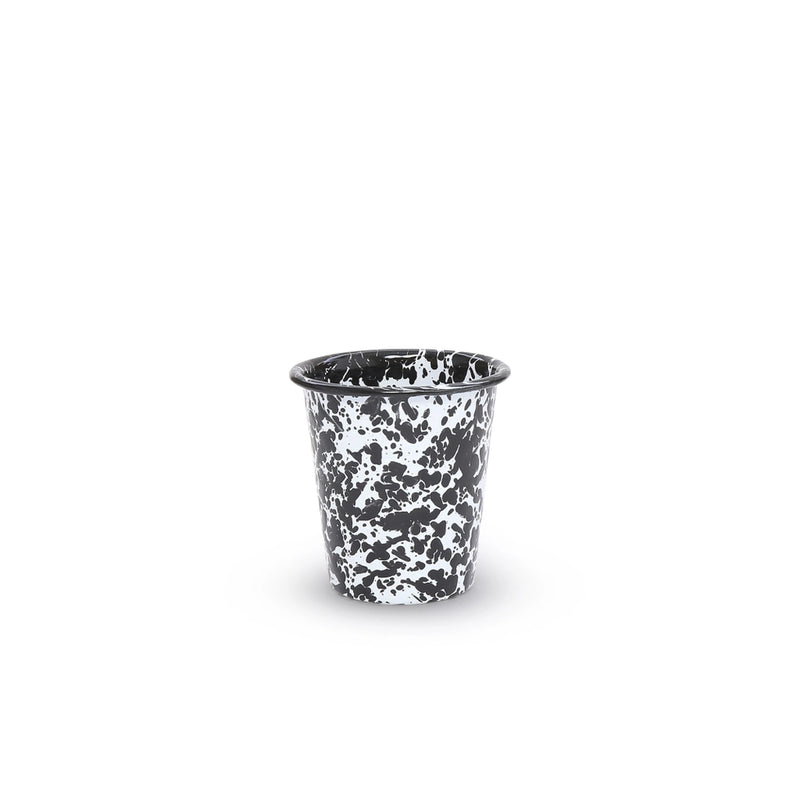 Black and white speckled cup on a white background