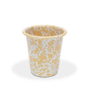 Enamel cup with yellow abstract pattern on a white background