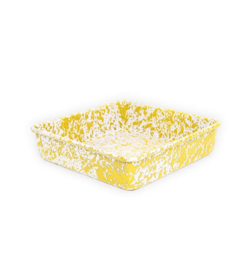 Yellow and white patterned dish on a white background