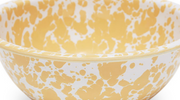 A set of three yellow and white marble/splatter pattern mixing bowls in different sizes.