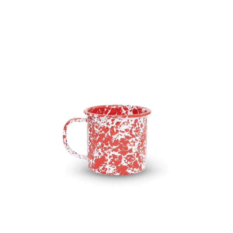 Red and white speckled mug on a white background