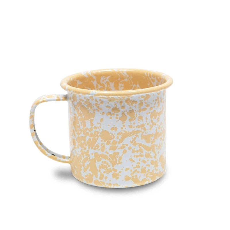 Yellow and white patterned mug on a white background