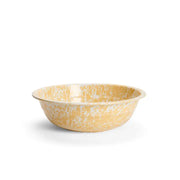 Yellow ceramic bowl with speckled pattern on a white background