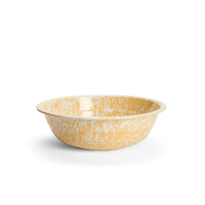 Yellow ceramic bowl with speckled pattern on a white background