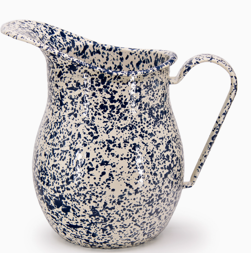 Speckled blue and white ceramic pitcher on a white background