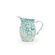 Speckled ceramic pitcher with a handle on a white background