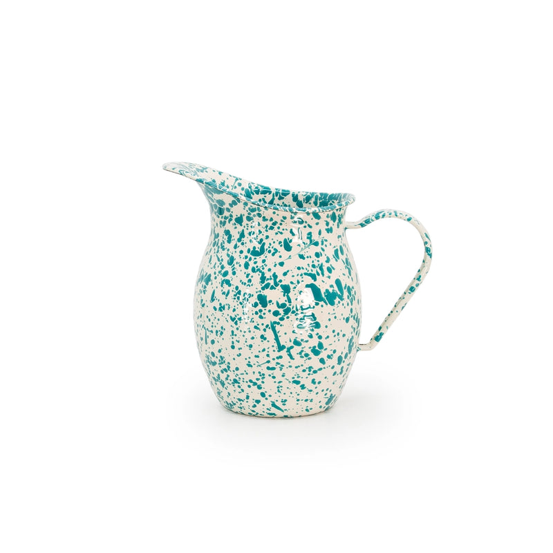Speckled ceramic pitcher with a handle on a white background