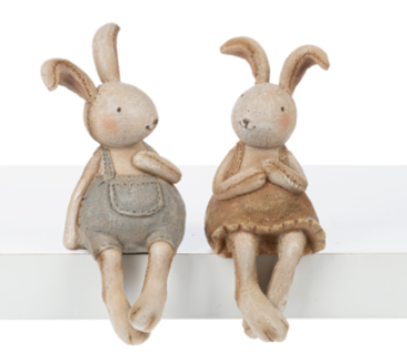 Two toy rabbits sitting on a white surface