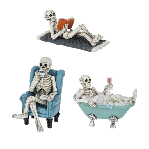 Three skeleton figurines in different poses on a white background