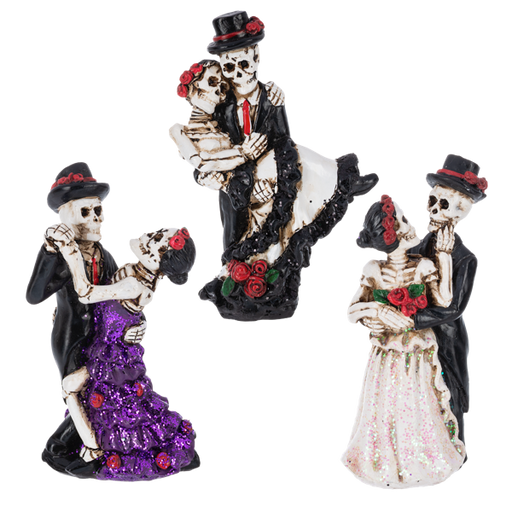 Three skeleton figurines in formal attire with decorative elements on a white background