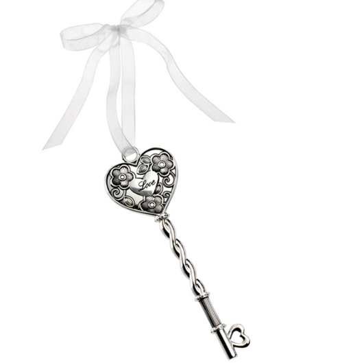 Decorative key with heart-shaped top and chain, tied with a white ribbon on a white background