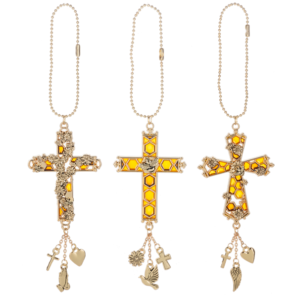 Three gold-toned cross necklaces with honeycomb yellow enamel details and dangling charms, displayed side by side on a white background.