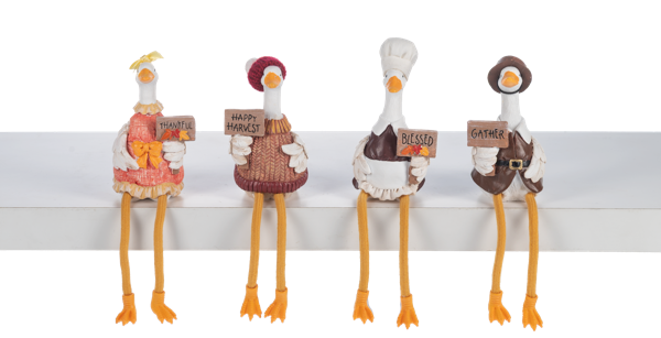 Four decorative goose figurines with signs on a white background