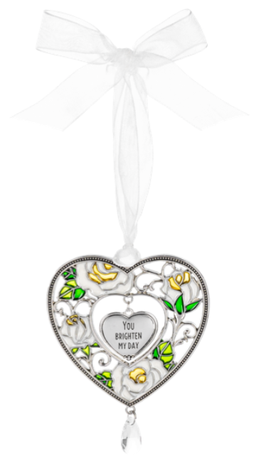 Decorative heart-shaped ornament with floral designs and text on a white background
