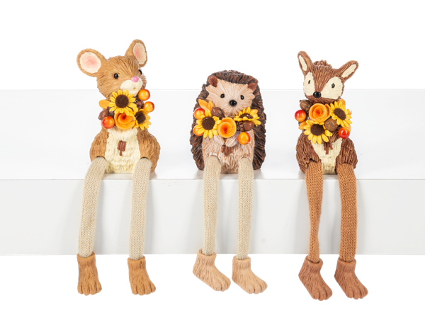 Three knitted animal dolls, resembling a deer, hedgehog, and rabbit, each holding a wreath of flowers on a white background.