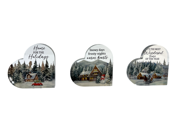 Three heart-shaped Christmas cards with winter scenes and text on a white background