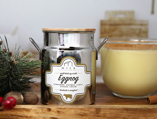 Jar of eggnog candle with a label on a wooden surface