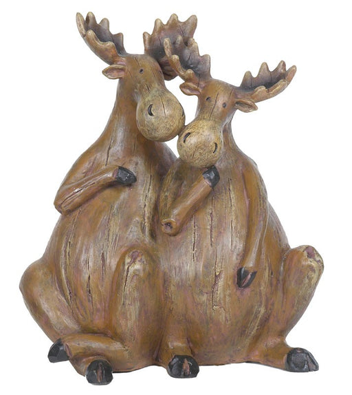 Decorative statue of two moose sitting together on a white background