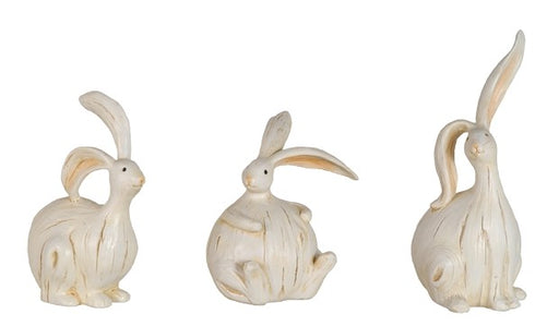 Three decorative shell sculptures shaped like rabbits on a white background