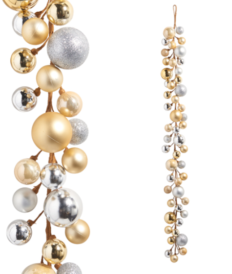 Decorative garland with gold, silver, and pearl beads on a white background