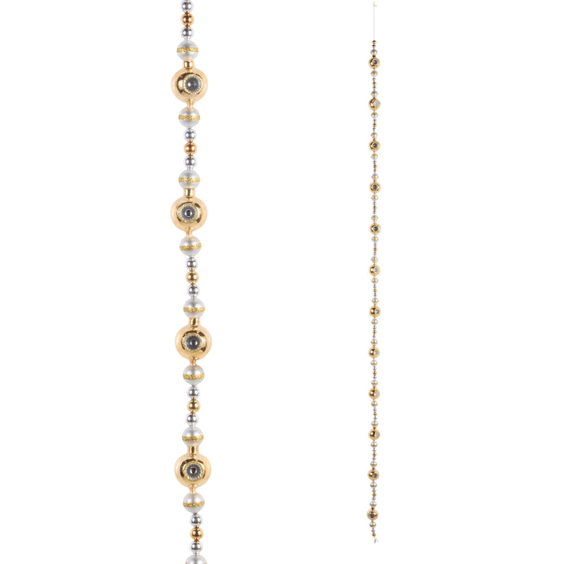 Long beaded garland with gold, silver, and black beads on a white background