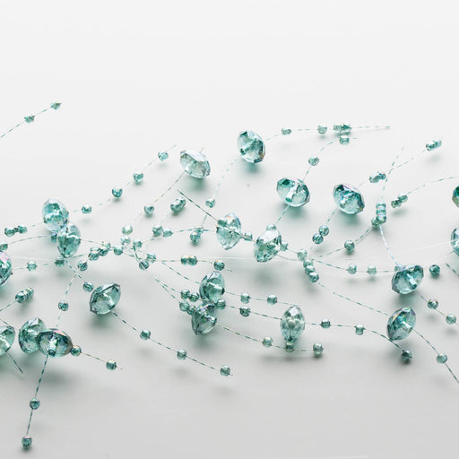 Teal crystal-like beads on a white background