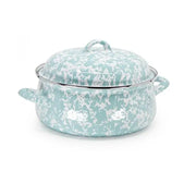 Turquoise and white patterned enamel cookware on a white background