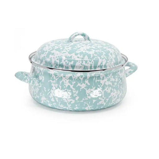 Turquoise and white patterned enamel cookware on a white background