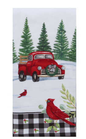 A terry towel with a printed design featuring a red truck, white snow, green trees, and red cardinals.