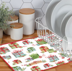 Kitchen scene with a decorative mat featuring Christmas gift designs, canisters, and a dish rack.