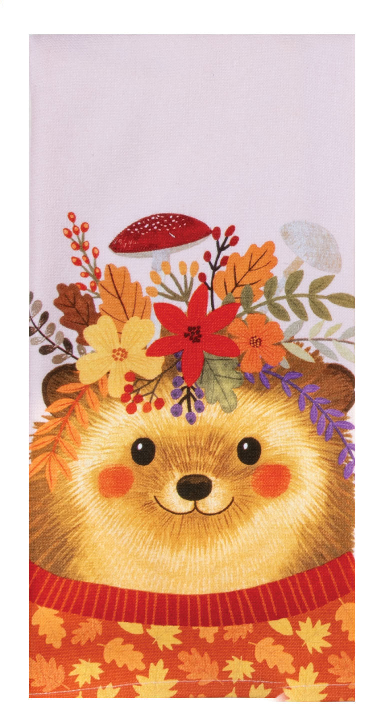 Towel with a cartoon bear wearing a floral headband and autumn-themed decorations on a white background