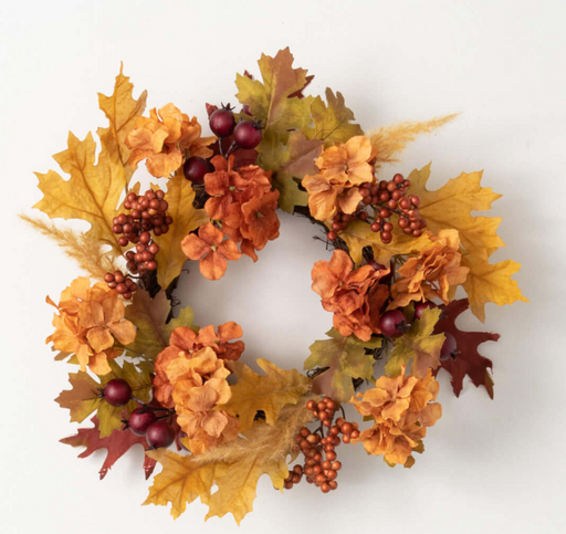 Autumn-themed wreath with leaves and berries on a white background