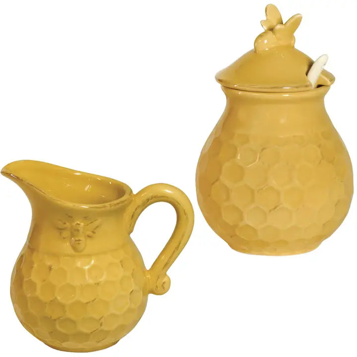 Yellow ceramic honey pot with lid on a white background