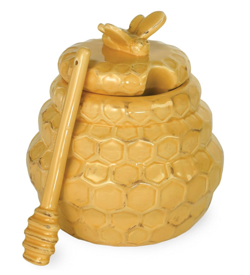 Yellow honey jar with a bee and honeycomb design on a white background