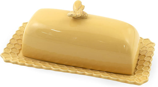 Yellow ceramic butter dish with lid on a white background