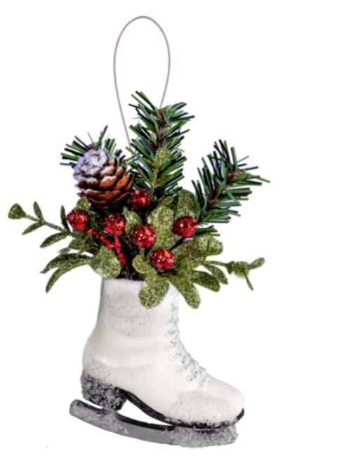 Decorative ice skate ornament with greenery and red berries on a white background