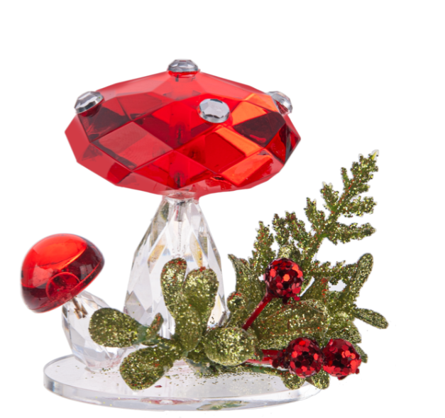 Decorative mushroom with red cap and green foliage on a white background