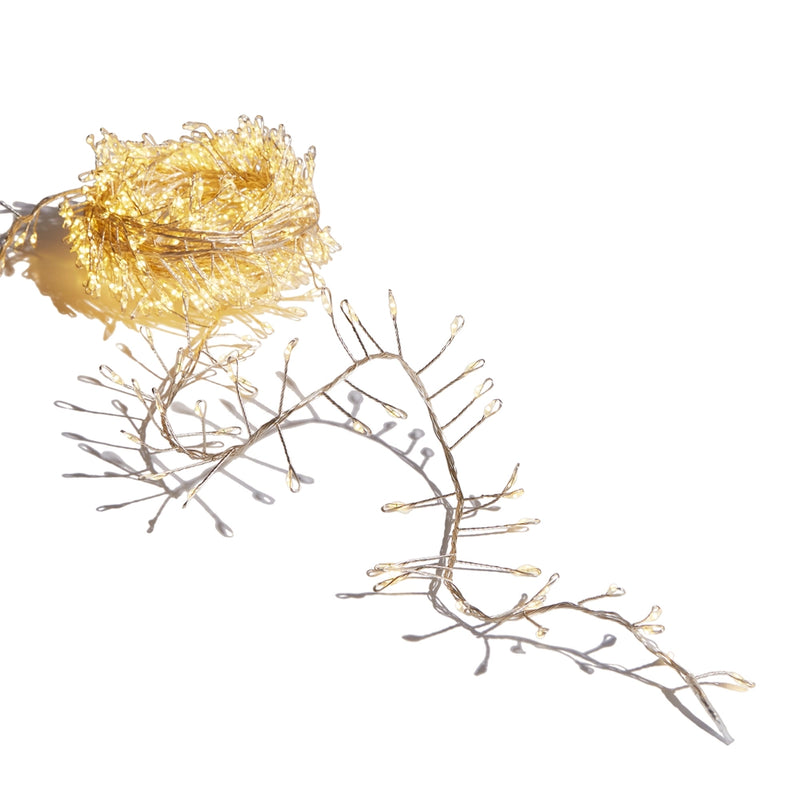 Decorative string lights shaped like branches on a white background