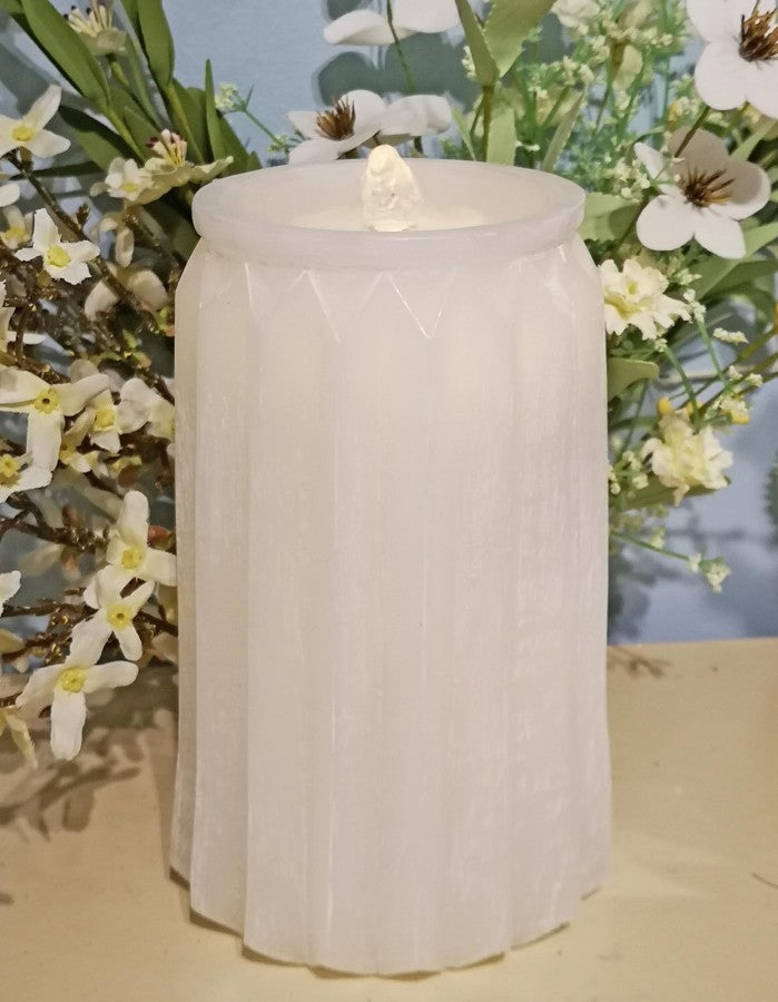 White textured candle with floral background