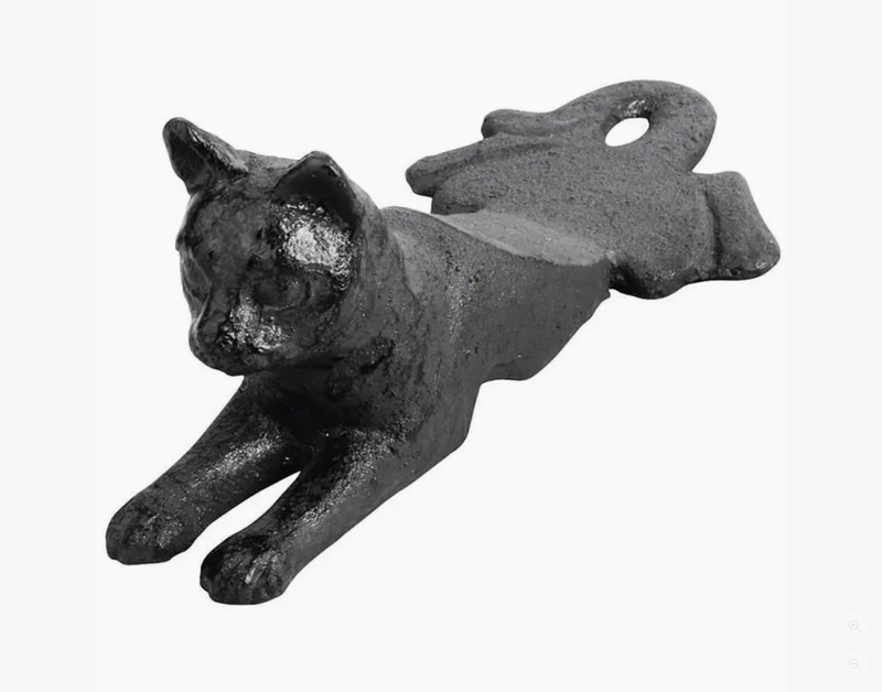 Cast iron cat-shaped door wedge on a white background