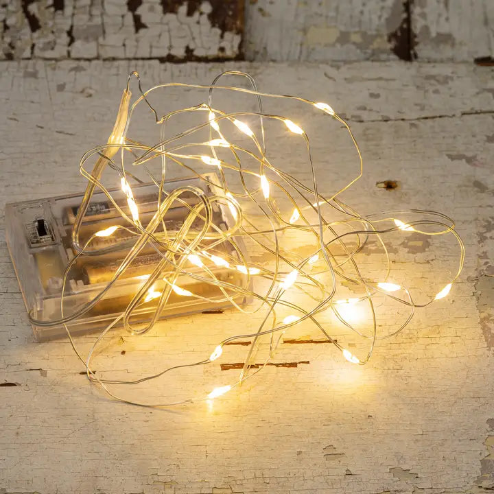 String of small lights on a rustic wooden surface