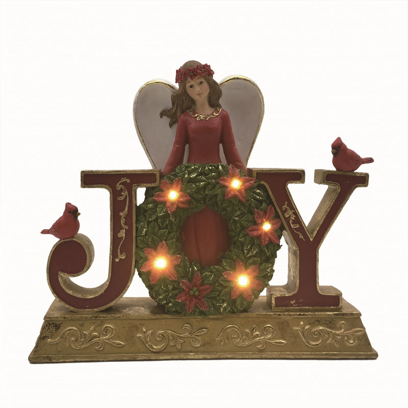Decorative Christmas figure with angel, wreath, and 'JOY' letters on a white background