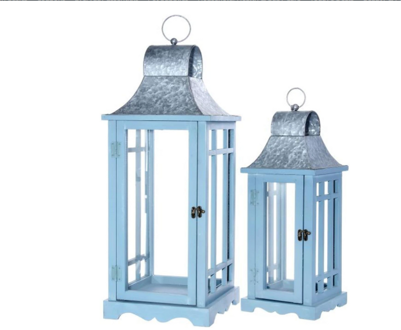 Two blue lanterns with galvanized roofs on a white background